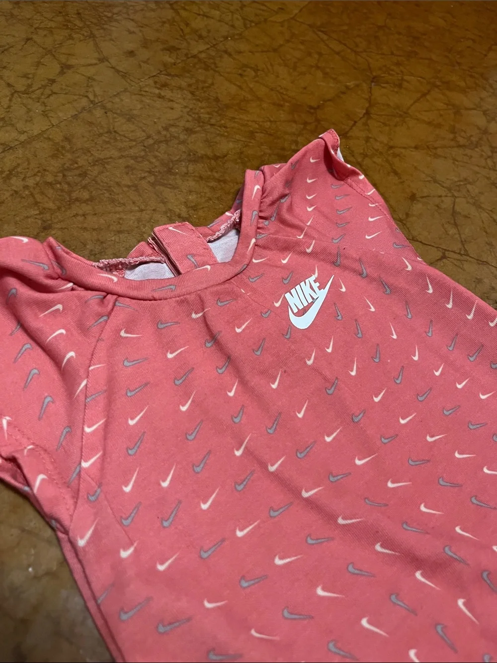 Nike Coral Pink Baby Romper with Repeat Swoosh Print